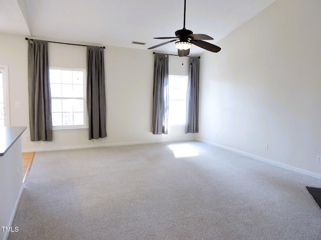 empty room with light carpet, plenty of natural light, visible vents, and baseboards