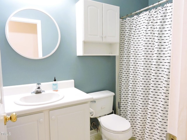 bathroom featuring toilet, vanity, and a shower with curtain