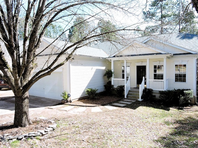 view of front of property featuring a garage, driveway, a porch, and roof with shingles