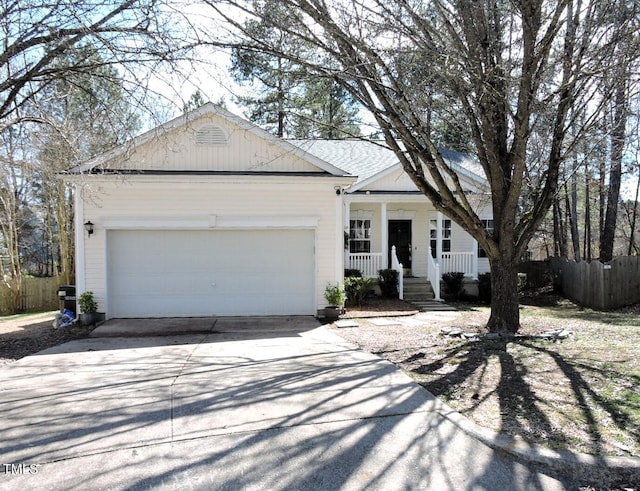 single story home featuring a garage, covered porch, fence, and concrete driveway