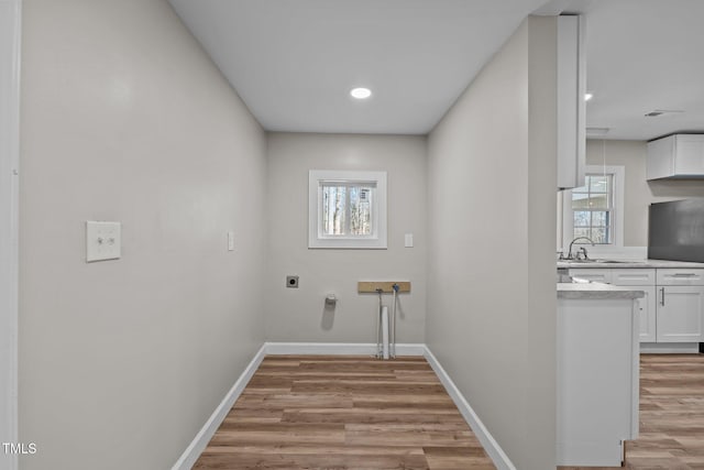 2810 Hickory Hill Rd, Burlington, NC 27215 - laundry room featuring a sink, electric dryer hookup, light wood-type flooring, laundry area, and baseboards