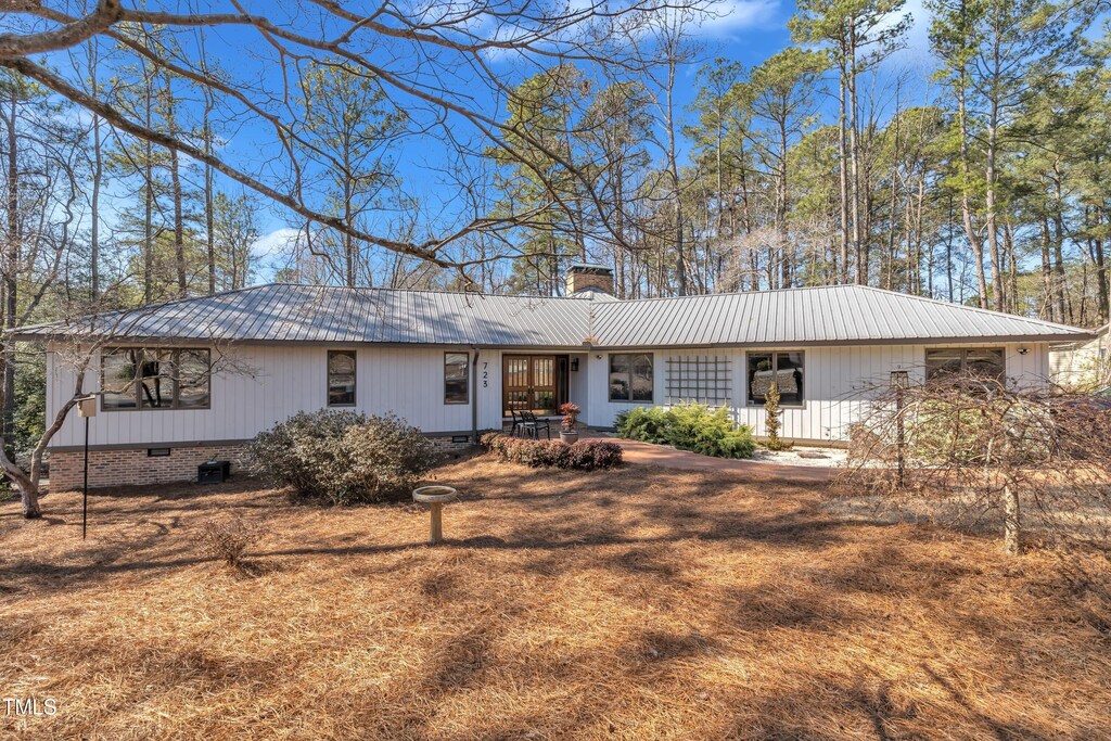 ranch-style house with crawl space, metal roof, and a chimney