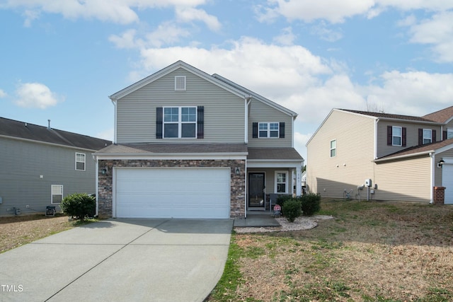 traditional home featuring stone siding, concrete driveway, a front lawn, and a garage