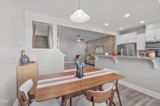 dining area with light wood finished floors, ceiling fan, baseboards, and recessed lighting