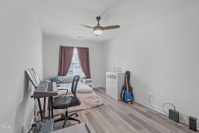 office area with baseboards, visible vents, ceiling fan, and light wood finished floors