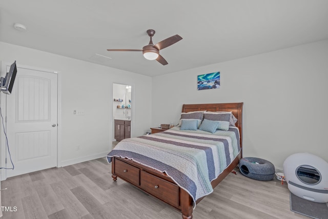 bedroom with light wood finished floors, ceiling fan, baseboards, and ensuite bathroom