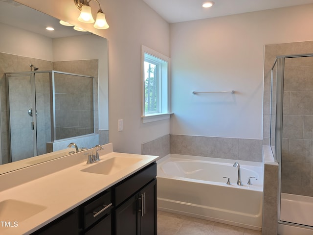 full bathroom with a stall shower, tile patterned flooring, a sink, and a bath