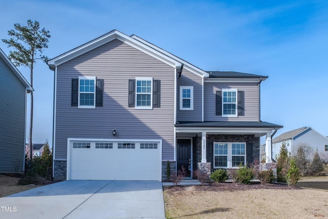 view of front of house with a garage, stone siding, and concrete driveway