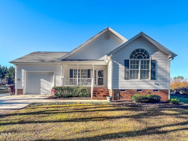 view of front of house featuring a garage, driveway, covered porch, and a front yard