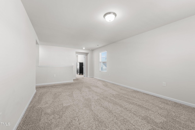 carpeted spare room with baseboards