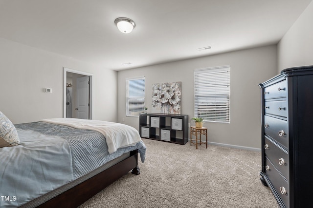 bedroom with carpet floors, visible vents, and baseboards