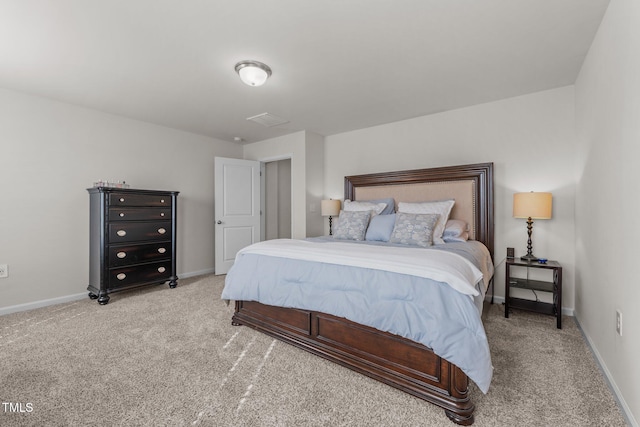 bedroom with baseboards and light colored carpet