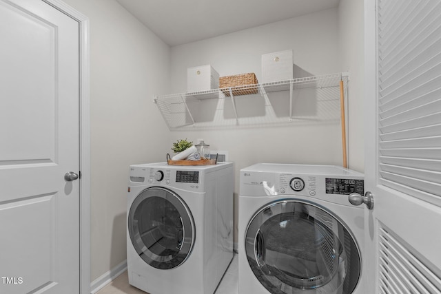 washroom featuring laundry area and washer and clothes dryer