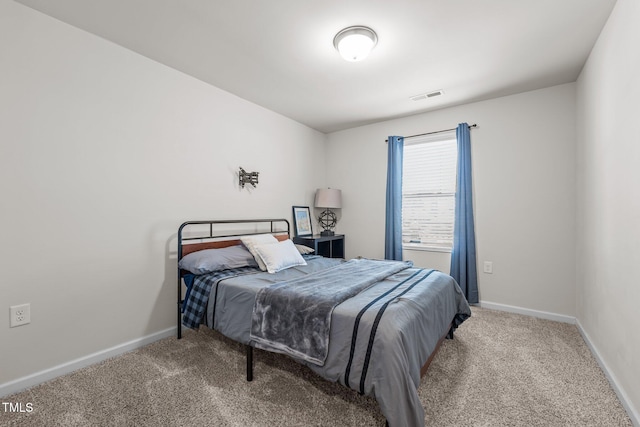 bedroom featuring carpet flooring, visible vents, and baseboards