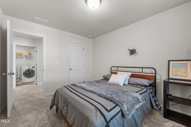 carpeted bedroom with washer and clothes dryer and baseboards