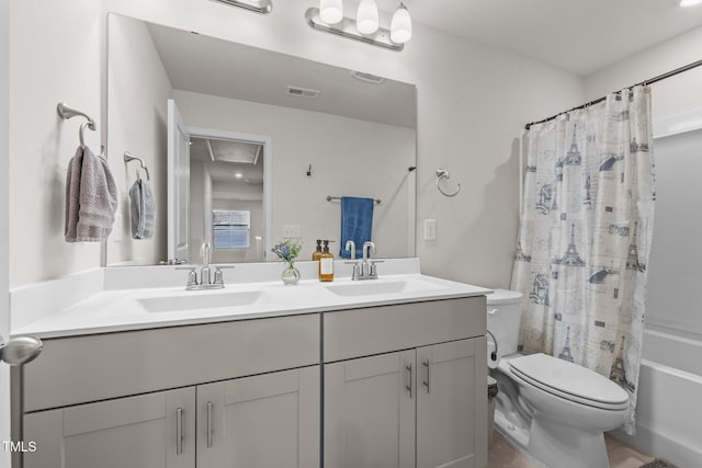 full bathroom featuring visible vents, a sink, toilet, and double vanity