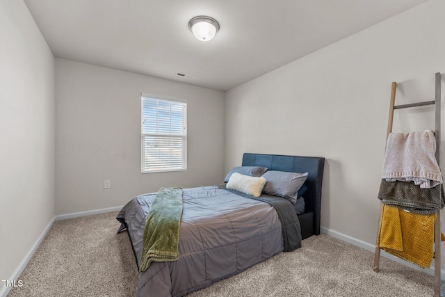 bedroom featuring baseboards, visible vents, and light colored carpet