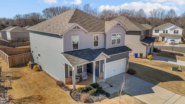 traditional home featuring concrete driveway, board and batten siding, fence, a garage, and cooling unit