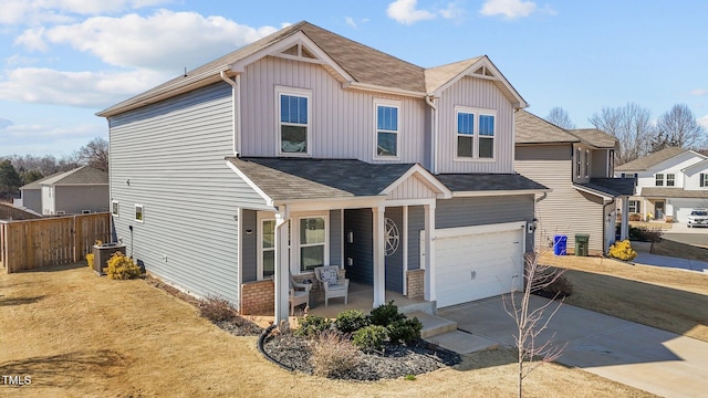 view of front of property featuring a garage, concrete driveway, fence, central AC, and board and batten siding