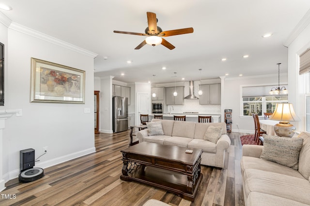 living room featuring baseboards, ornamental molding, wood finished floors, and recessed lighting