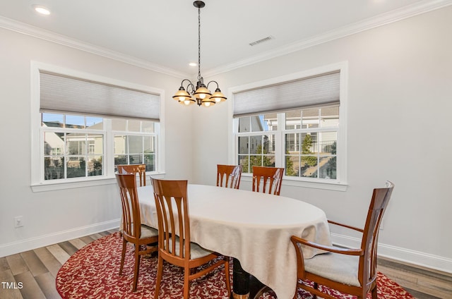 dining room with baseboards, wood finished floors, and a healthy amount of sunlight