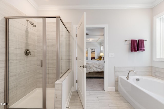 bathroom featuring baseboards, a shower stall, a bath, ensuite bath, and crown molding