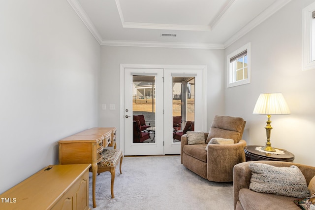 living area with visible vents, light colored carpet, a tray ceiling, crown molding, and french doors