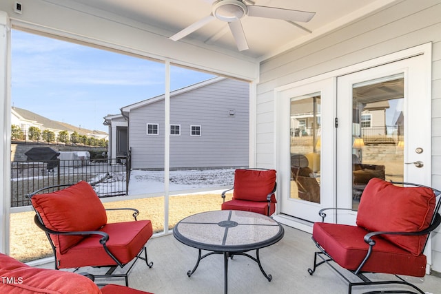 sunroom / solarium with a ceiling fan