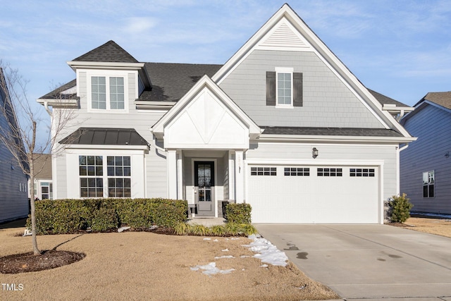 view of front of house featuring driveway, metal roof, roof with shingles, an attached garage, and a standing seam roof