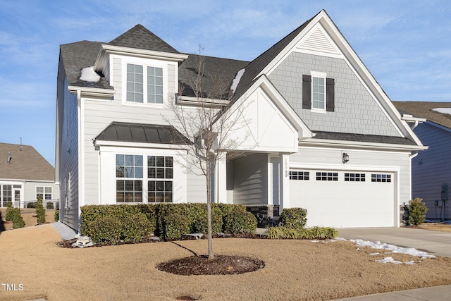 view of front facade featuring metal roof, an attached garage, concrete driveway, roof with shingles, and a standing seam roof