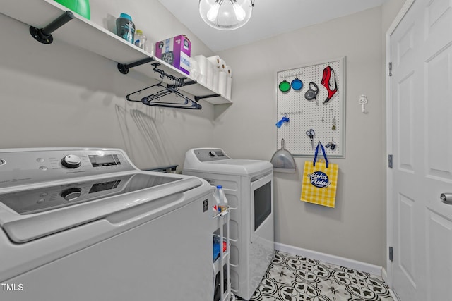 washroom featuring washer and dryer, baseboards, and tile patterned flooring