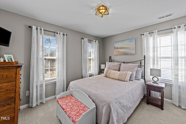 bedroom featuring baseboards and light colored carpet