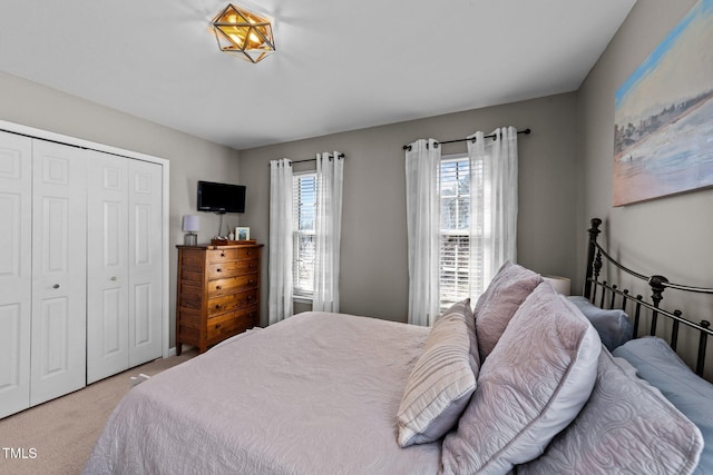 bedroom with light carpet and a closet
