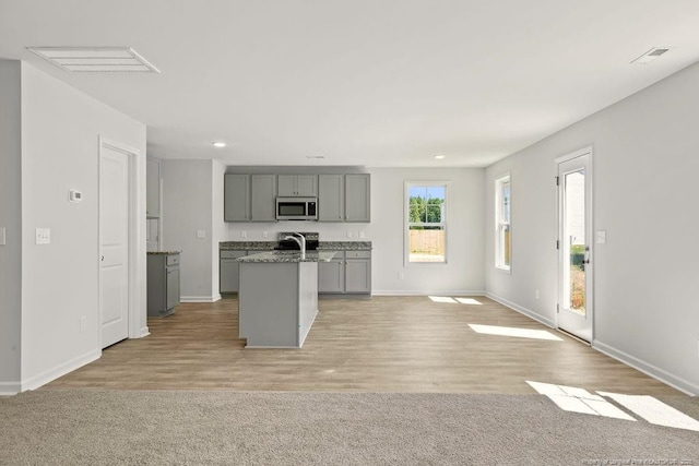 814 Tori Dr, Spring Lake, NC 28390 - kitchen with gray cabinets, stainless steel appliances, baseboards, an island with sink, and recessed lighting