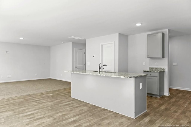 814 Tori Dr, Spring Lake, NC 28390 - kitchen featuring gray cabinetry, a sink, wood finished floors, baseboards, and recessed lighting