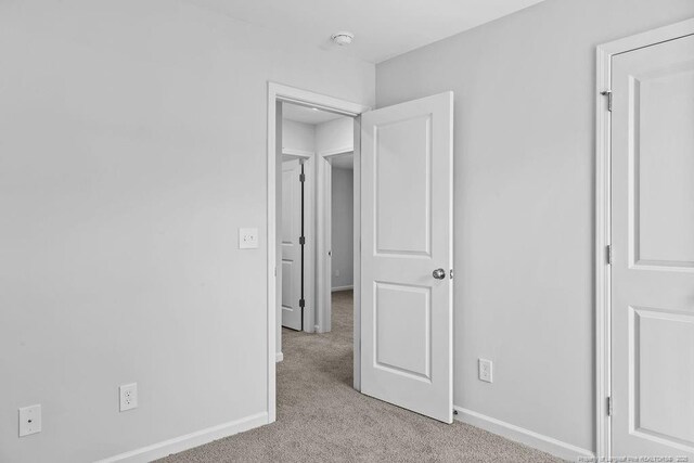 814 Tori Dr, Spring Lake, NC 28390 - unfurnished bedroom featuring light carpet and baseboards