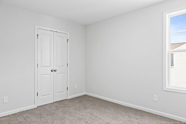 814 Tori Dr, Spring Lake, NC 28390 - unfurnished bedroom with carpet flooring, baseboards, and a closet