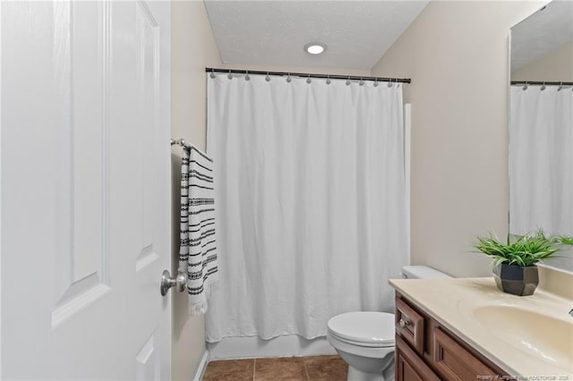 full bath with tile patterned flooring, toilet, a textured ceiling, and vanity