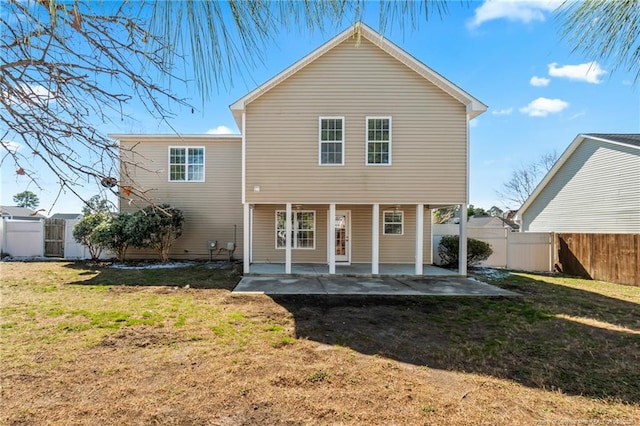 back of property featuring a yard, a fenced backyard, and a patio