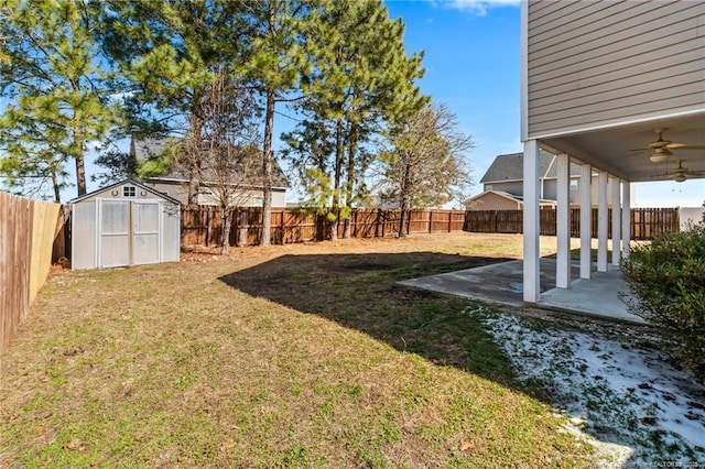 view of yard with a fenced backyard, ceiling fan, an outdoor structure, a patio area, and a shed