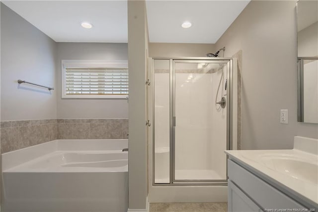 full bath with recessed lighting, a garden tub, a shower stall, and vanity