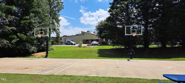 view of basketball court with basketball court and a yard