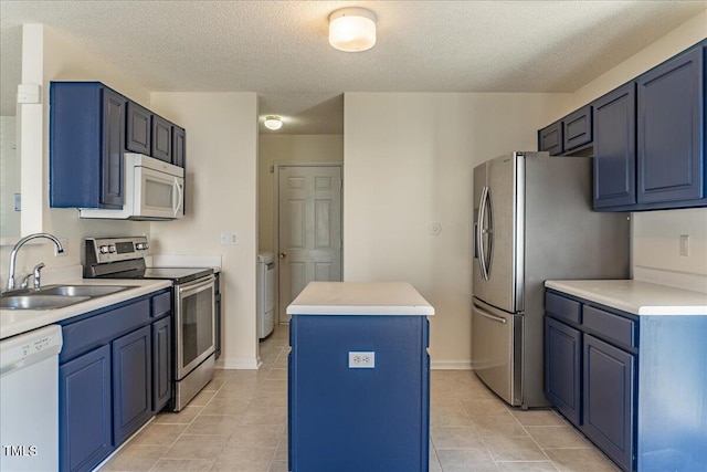 kitchen with a center island, blue cabinetry, stainless steel appliances, light countertops, and a sink