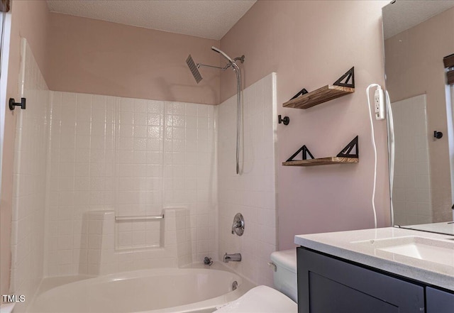 bathroom featuring toilet, vanity, a textured ceiling, and bathing tub / shower combination