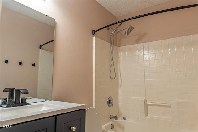 bathroom with a textured ceiling, toilet, shower / bathtub combination, and vanity