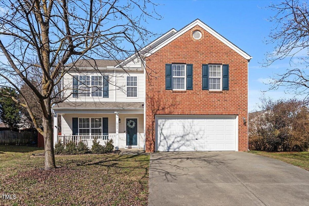 1005 Cookwood Ct, Raleigh, NC 27610 - traditional-style house featuring a garage, covered porch, aphalt driveway, and brick siding