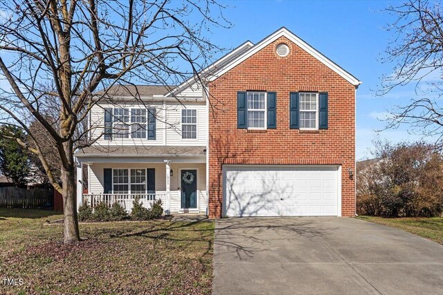 1005 Cookwood Ct, Raleigh, NC 27610 - traditional-style house featuring a garage, covered porch, aphalt driveway, and brick siding