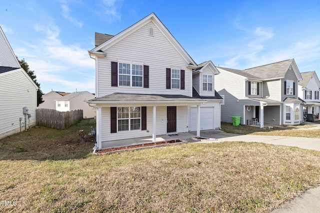 view of front facade with covered porch, a garage, fence, driveway, and a front yard