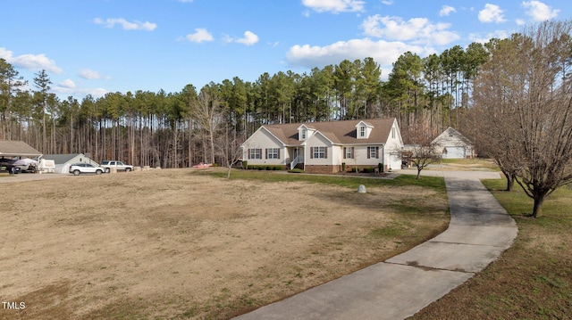 cape cod house featuring a front yard and a view of trees