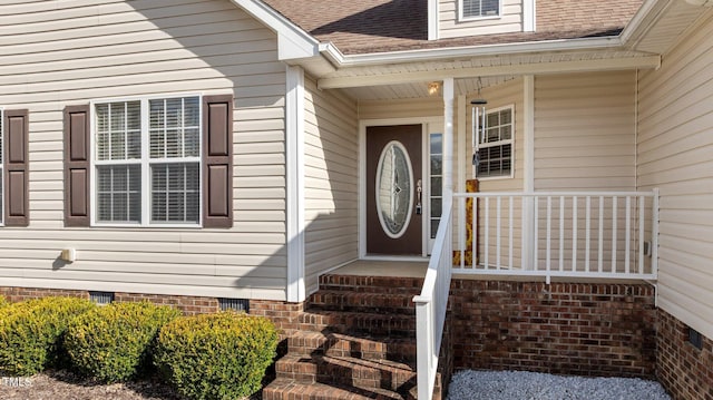 doorway to property featuring crawl space and roof with shingles